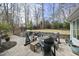 Stunning outdoor patio featuring a fire pit, comfortable seating, grill and lush backyard; ideal for entertaining at 400 Edinburgh Dr, Cary, NC 27511