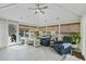 Bright sun room with many windows, ceiling fan, neutral furniture and tiled floor at 400 Edinburgh Dr, Cary, NC 27511
