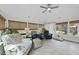 Bright sun room with many windows, ceiling fan, neutral furniture and tiled floor at 400 Edinburgh Dr, Cary, NC 27511