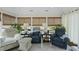 Bright sun room with many windows, ceiling fan, neutral furniture and tiled floor at 400 Edinburgh Dr, Cary, NC 27511