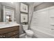Well-appointed bathroom showcasing a vanity, toilet, and tub-shower combo with modern decorative accents at 4002 Kidd Pl, Durham, NC 27703