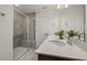 Modern bathroom featuring a glass shower, double vanity with quartz countertop, and neutral color scheme at 4002 Kidd Pl, Durham, NC 27703