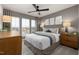 Cozy bedroom with large windows, stylish ceiling fan, neutral decor, and comfortable bedding at 4002 Kidd Pl, Durham, NC 27703