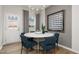 Dining area with modern chandelier, neutral gray wall color, and outdoor access at 4002 Kidd Pl, Durham, NC 27703