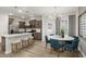 Open concept kitchen and dining area with stainless appliances, granite island, and modern chandelier at 4002 Kidd Pl, Durham, NC 27703