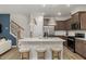 Open kitchen features a large island with seating, granite counters, and stainless steel appliances at 4002 Kidd Pl, Durham, NC 27703