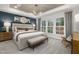 Spacious main bedroom with ample natural light, tray ceiling, and modern chandelier at 4002 Kidd Pl, Durham, NC 27703