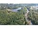 Stunning aerial view of community with mature trees, scenic waterway, and convenient access to nearby amenities at 4060 Granite Ridge Trl, Raleigh, NC 27616