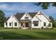 Charming two-story modern farmhouse with inviting front porch and beautifully landscaped front yard at 4060 Granite Ridge Trl, Raleigh, NC 27616