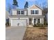 Charming two-story home featuring a two-car garage and manicured front yard at 449 Willard Woods Dr, Wendell, NC 27591