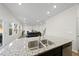 Modern kitchen featuring granite countertops and stainless steel sink at 449 Willard Woods Dr, Wendell, NC 27591