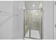 Shower with glass doors, a built-in seat, and tiled walls in a contemporary bathroom at 449 Willard Woods Dr, Wendell, NC 27591