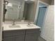 Bathroom with a double sink vanity with gray cabinets at 4807 Tyne Drive, Durham, NC 27703