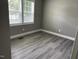 Bedroom featuring luxury vinyl flooring and a window at 4807 Tyne Drive, Durham, NC 27703
