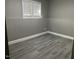 The room features a window with horizontal blinds and gray vinyl flooring at 4807 Tyne Drive, Durham, NC 27703