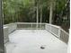 View of a wood deck surrounded by trees and foliage at 4807 Tyne Drive, Durham, NC 27703