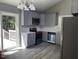Updated kitchen with stainless appliances, gray cabinets, and luxury vinyl flooring at 4807 Tyne Drive, Durham, NC 27703