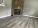 Living room features luxury vinyl flooring and stone fireplace at 4807 Tyne Drive, Durham, NC 27703