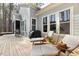 Relaxing back deck area with a grill, comfortable lounge chairs, and views of the serene, wooded backyard at 49 Bonterra Way, Chapel Hill, NC 27516