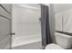 Clean bathroom with a tub and shower combo, tile walls, and sleek fixtures at 49 Bonterra Way, Chapel Hill, NC 27516
