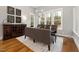 Cozy dining room with modern chandelier and large windows with wooded view at 49 Bonterra Way, Chapel Hill, NC 27516