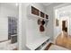 Entryway with a bench, storage cubbies, woven baskets, and a coat rack and closet at 49 Bonterra Way, Chapel Hill, NC 27516