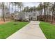 Elegant home exterior with a well-manicured lawn and a long driveway leading to the residence at 49 Bonterra Way, Chapel Hill, NC 27516