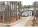 Beautiful home nestled among the trees, featuring a long driveway and well-maintained landscaping at 49 Bonterra Way, Chapel Hill, NC 27516