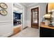 A bright foyer leads to an office with blue walls and a hardwood floor at 49 Bonterra Way, Chapel Hill, NC 27516