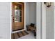 Close-up view of charming wood door with black hardware and welcoming bench at 49 Bonterra Way, Chapel Hill, NC 27516