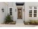 Inviting front entry with charming wood door, black sconces, and stylish awning at 49 Bonterra Way, Chapel Hill, NC 27516