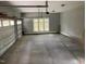 Large garage with a concrete floor, exposed pipes and a window for natural light at 49 Bonterra Way, Chapel Hill, NC 27516