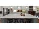 Bright kitchen features a large center island with seating, granite countertops, and stainless appliances at 49 Bonterra Way, Chapel Hill, NC 27516