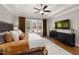 Spacious main bedroom with tray ceiling, hardwood floors, and picturesque window views at 49 Bonterra Way, Chapel Hill, NC 27516