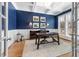 This stylish home office features blue walls and abundant natural light at 49 Bonterra Way, Chapel Hill, NC 27516