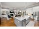 Open floor plan with kitchen island overlooking living room fireplace and built-in shelving at 49 Bonterra Way, Chapel Hill, NC 27516