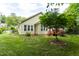 The backyard features mature trees, a healthy green lawn, and a wooden deck at 4909 Willow Tree Ln, Clayton, NC 27520