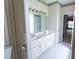 Bathroom featuring a double sink vanity and colorful wallpaper at 4909 Willow Tree Ln, Clayton, NC 27520