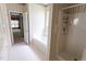 Bright bathroom featuring a shower, bathtub, and colorful wallpaper at 4909 Willow Tree Ln, Clayton, NC 27520
