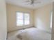 Bedroom with carpet and neutral walls, ceiling fan, and window at 4909 Willow Tree Ln, Clayton, NC 27520