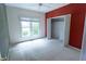 Bright bedroom featuring a large window, closet, and neutral carpet at 4909 Willow Tree Ln, Clayton, NC 27520
