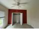 Bright carpeted bedroom featuring a ceiling fan, window with blinds, and closet with folding doors at 4909 Willow Tree Ln, Clayton, NC 27520