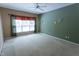 Spacious bedroom featuring a large window, ceiling fan, and neutral carpet at 4909 Willow Tree Ln, Clayton, NC 27520