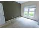 Bedroom featuring a large window and neutral carpet at 4909 Willow Tree Ln, Clayton, NC 27520