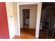 Interior view of a home's entrance, showcasing hardwood flooring and a utility room beyond at 4909 Willow Tree Ln, Clayton, NC 27520
