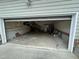 Large garage featuring open garage door and staircase access to the interior of the home at 4909 Willow Tree Ln, Clayton, NC 27520