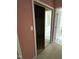Hallway with mirrored closet and a bathroom with striped wallpaper in the background at 4909 Willow Tree Ln, Clayton, NC 27520