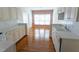 Bright kitchen featuring white cabinets and hardwood floors at 4909 Willow Tree Ln, Clayton, NC 27520
