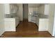 Spacious kitchen featuring white cabinets and hardwood floors at 4909 Willow Tree Ln, Clayton, NC 27520