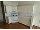 Kitchen area with white appliances, cabinets, and hardwood floors at 4909 Willow Tree Ln, Clayton, NC 27520